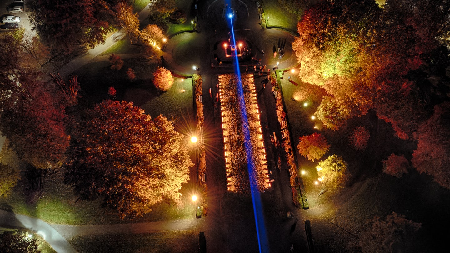 A bright, chaotic night scene from Lights in Alingsås with computers, light structures and scattered visitors.