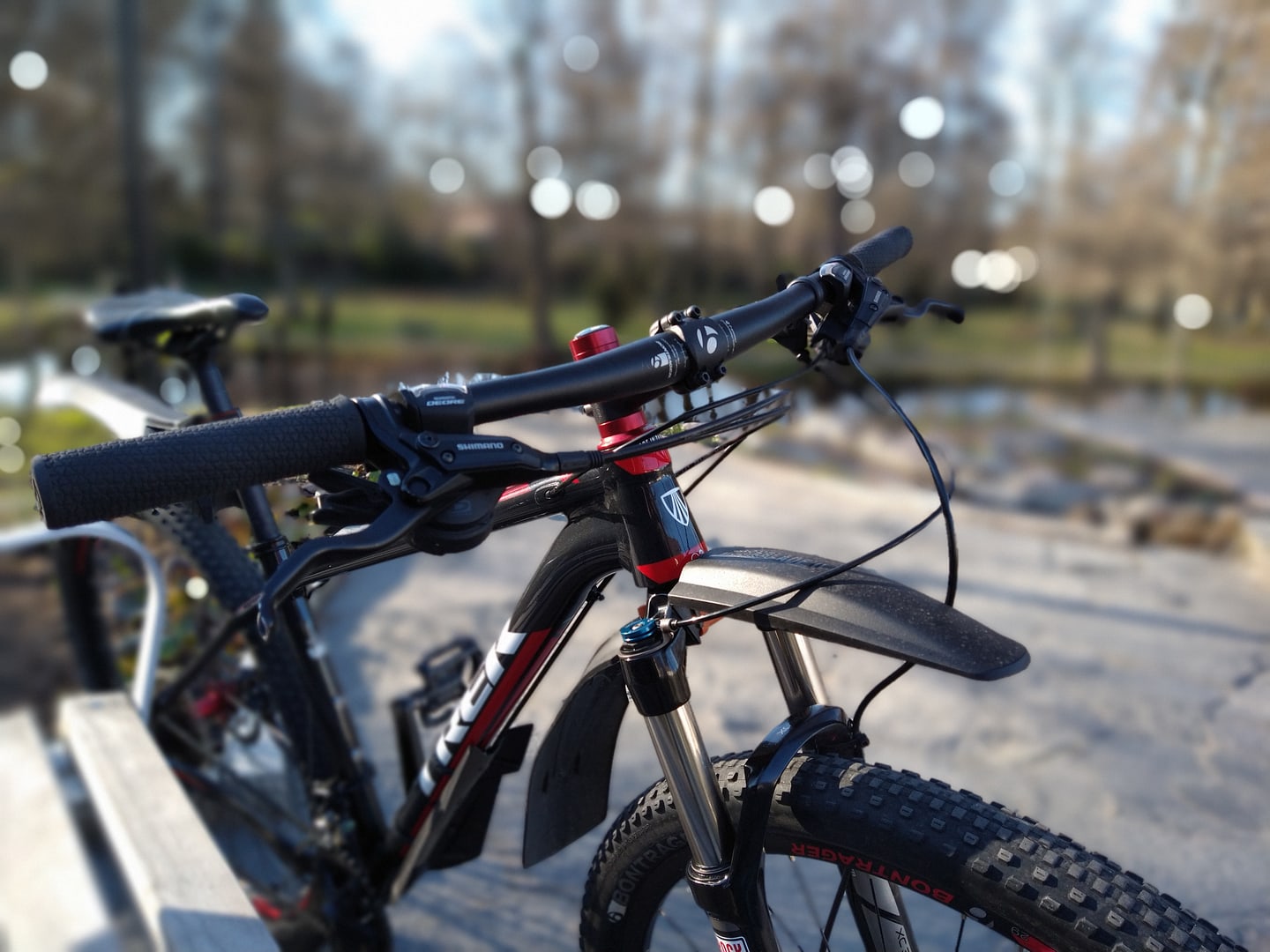 Close-up of a mountain bike handlebar in evening light.